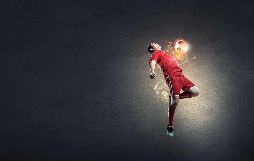 Jpg. Football player in red shirt jump taking ball